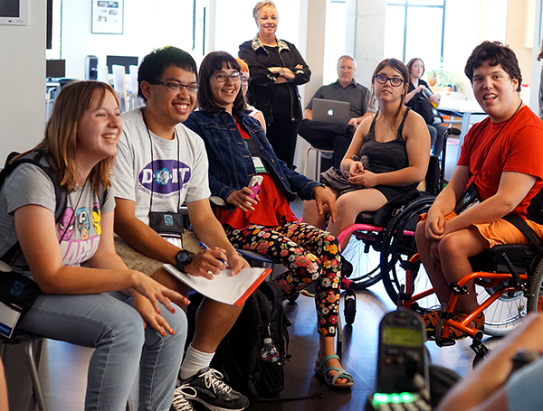 Students laugh and smile as they work on a project