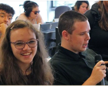 A girl and a boy sit next to each other during class
