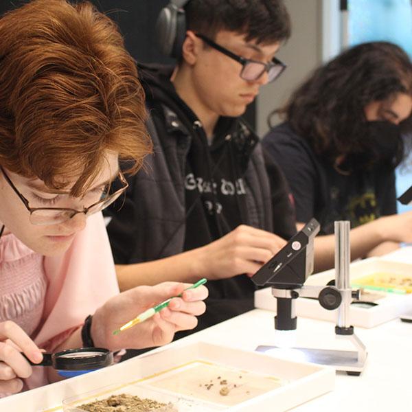 Student using a magnifying glass