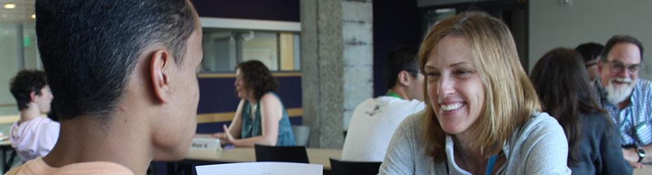 A woman smiling at a student