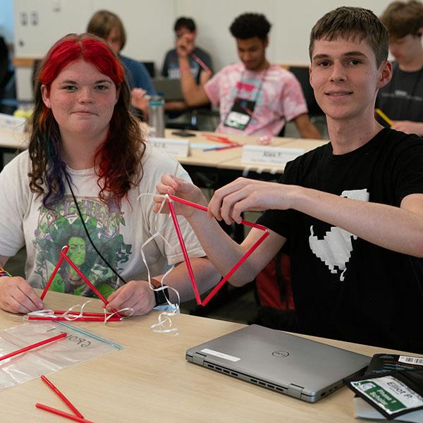 Two students building a kite