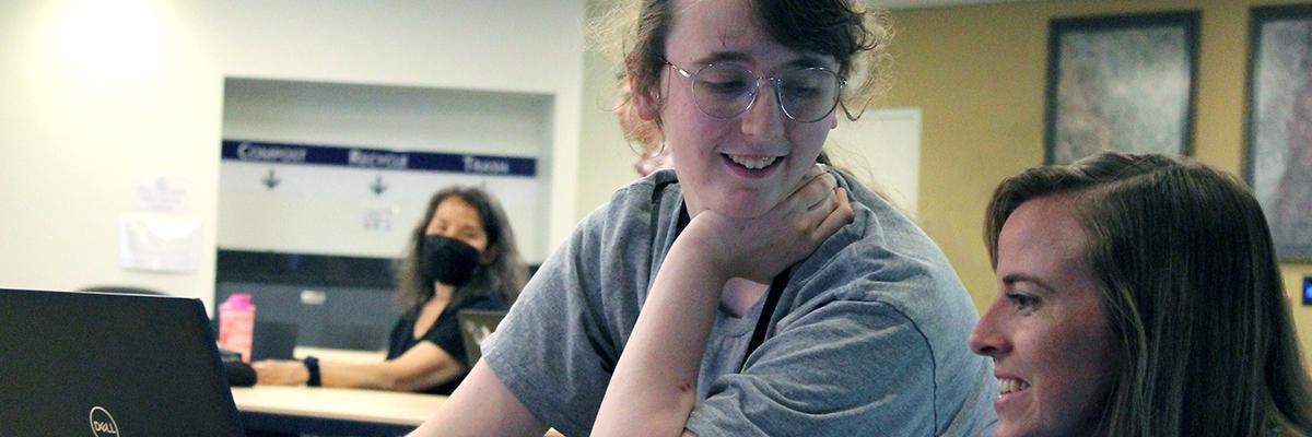 A student smiling at a woman