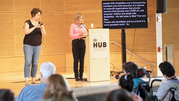 Two speakers on a stage