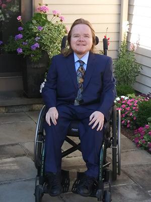 Carl Dunlap sitting in a wheelchair